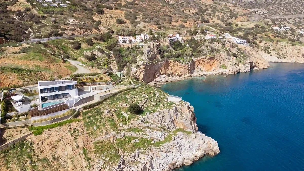 Aerial view of Meltemi Villa perched on cliff above the Aegean Sea, Heraklion Crete
