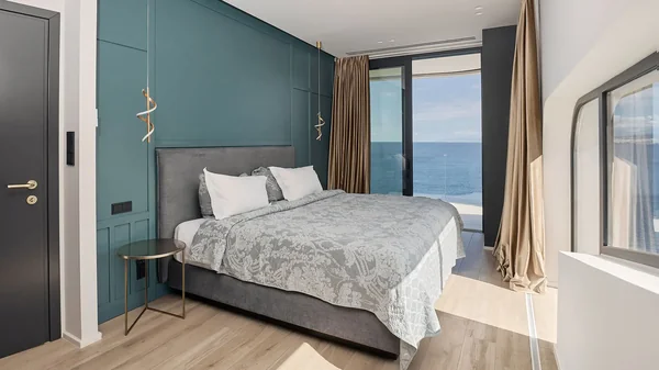 Sea-view bedroom with teal accents